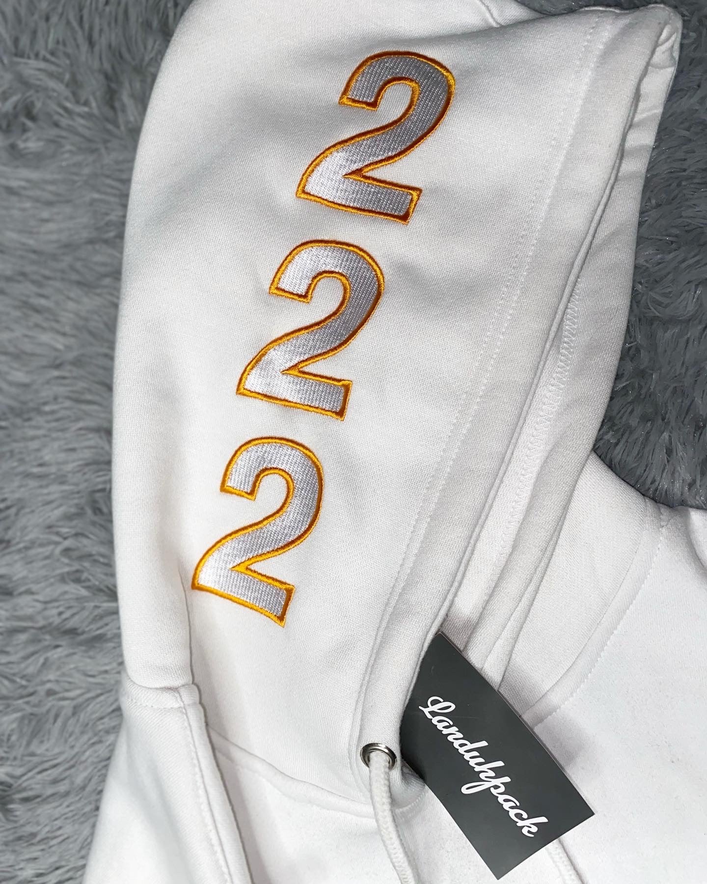 White landuhpack hoodie with angle number 222